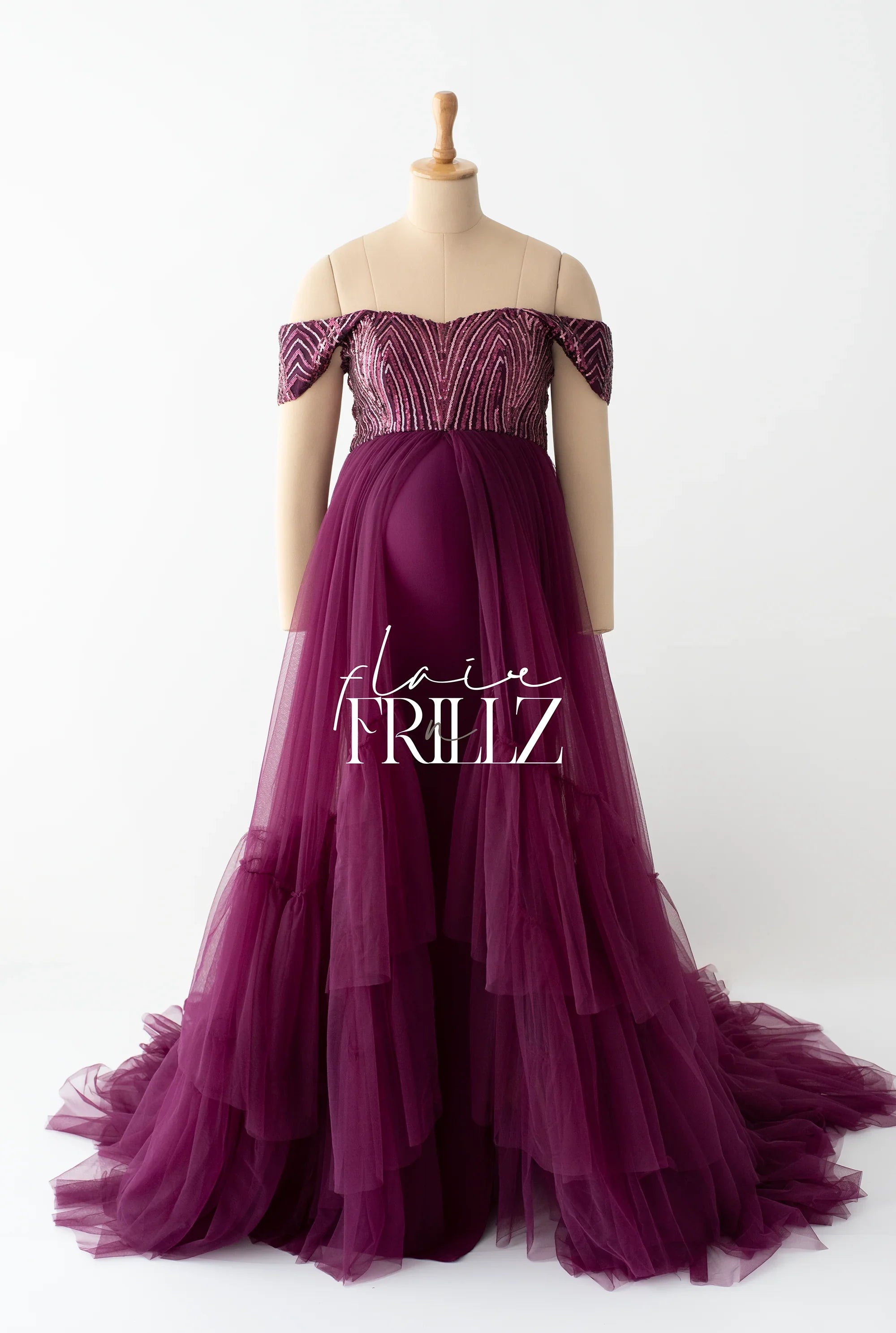 Purple off-shoulder maternity gown with beaded bodice and layered tulle skirt on mannequin