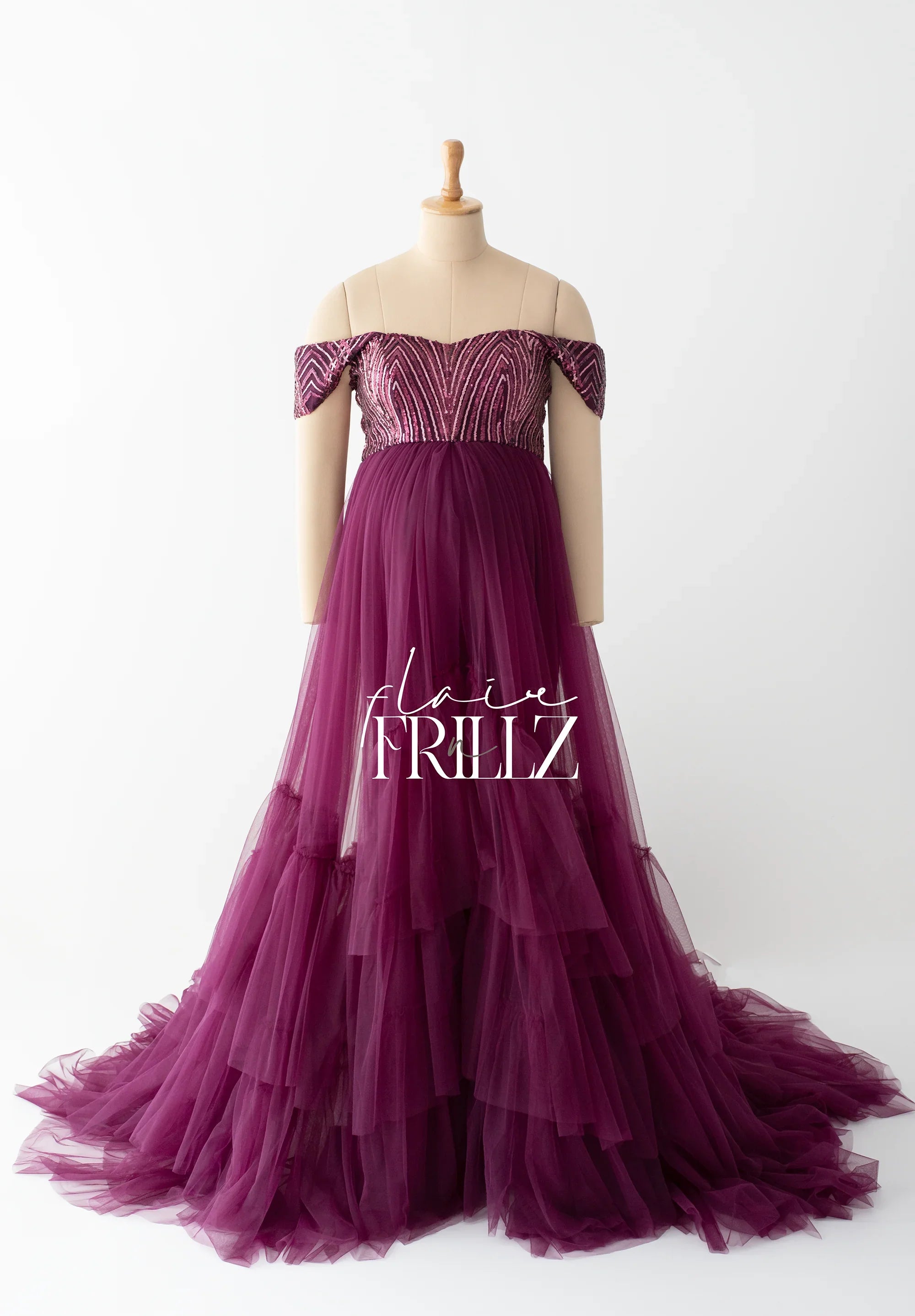 Plum purple off-shoulder maternity gown with beaded bodice and layered tulle skirt on mannequin