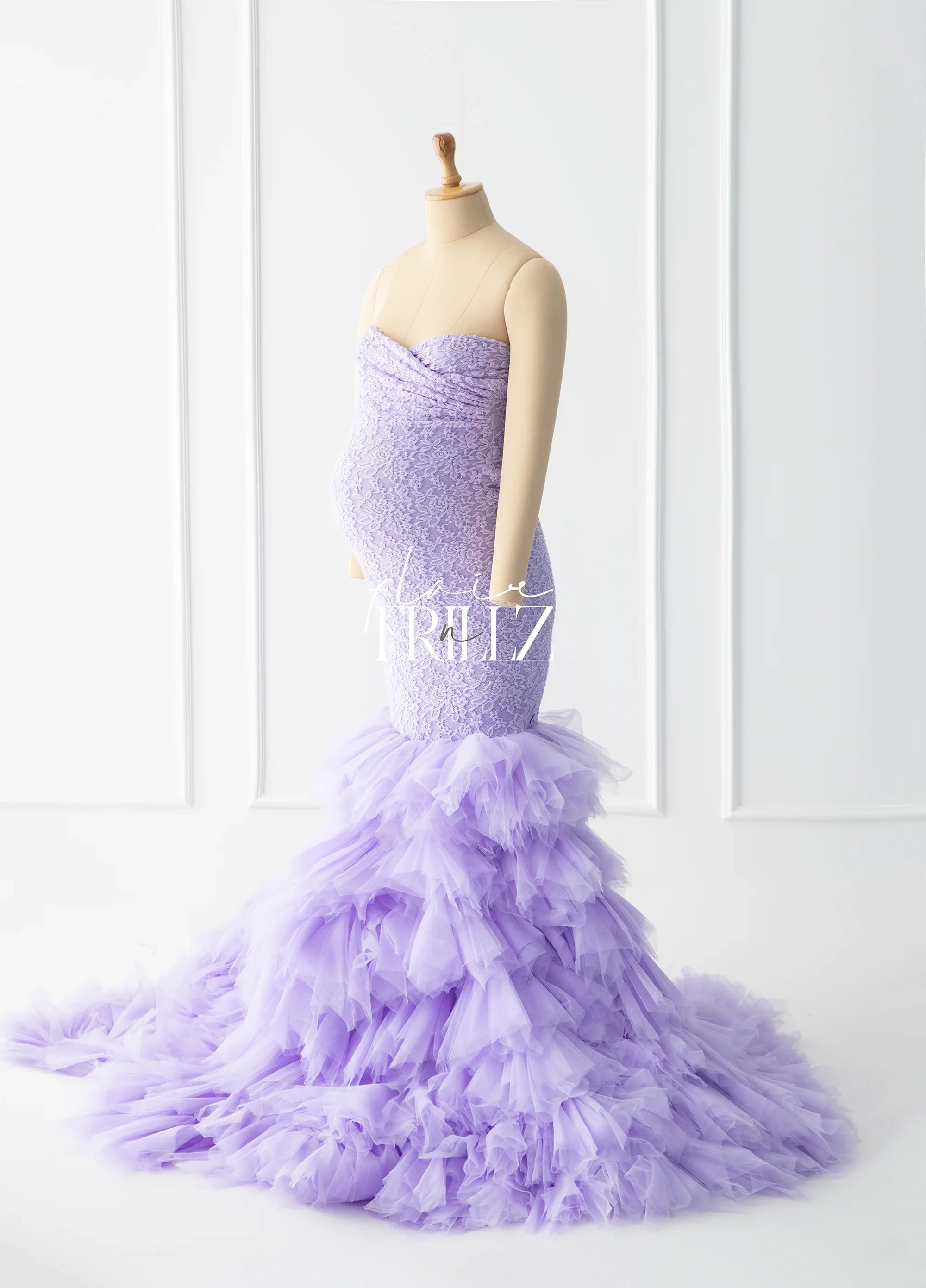 Lavender lace maternity gown with ruffled tulle mermaid skirt on mannequin
