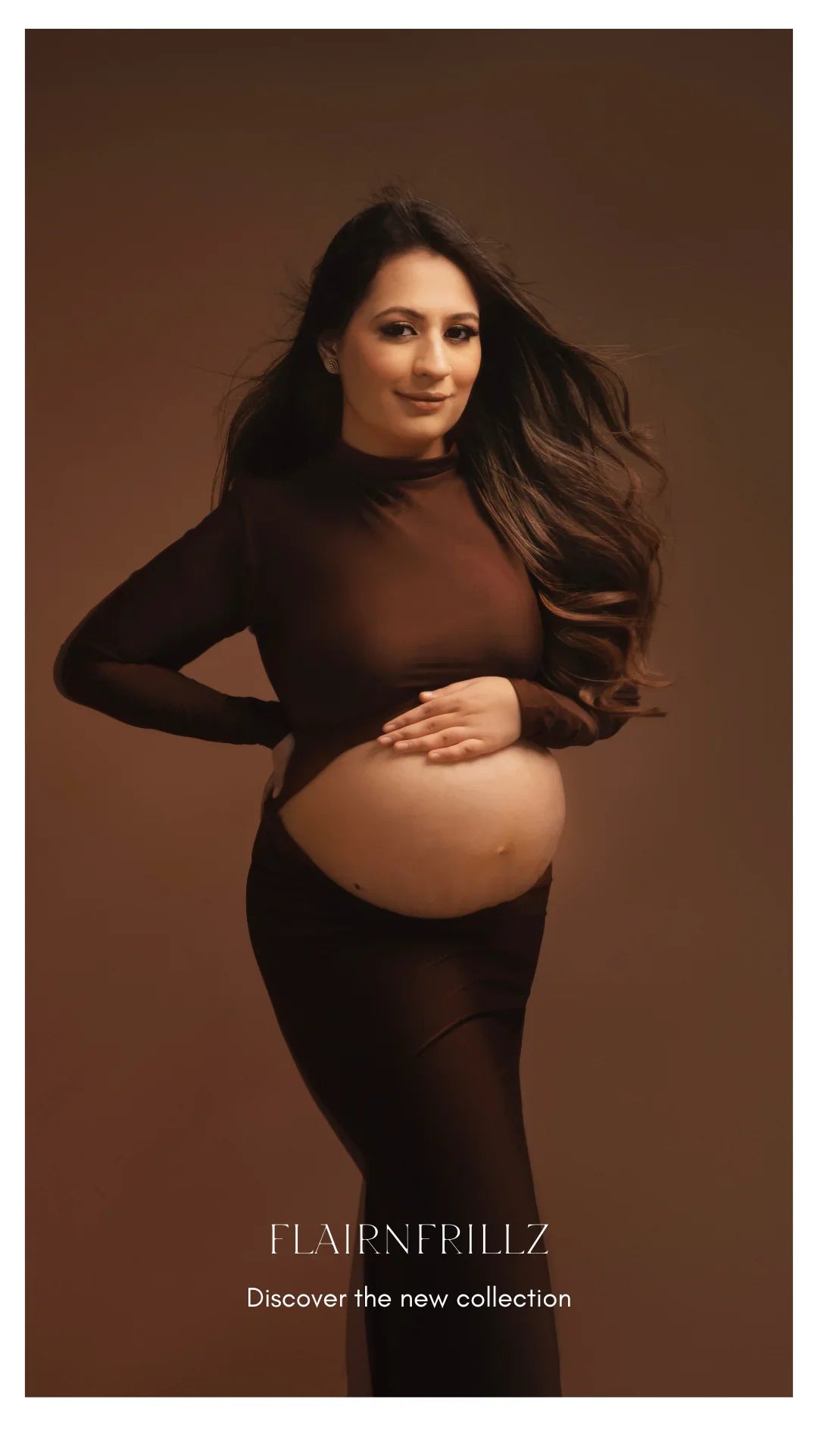 Pregnant woman in elegant brown maternity wear, posing on a warm studio background.