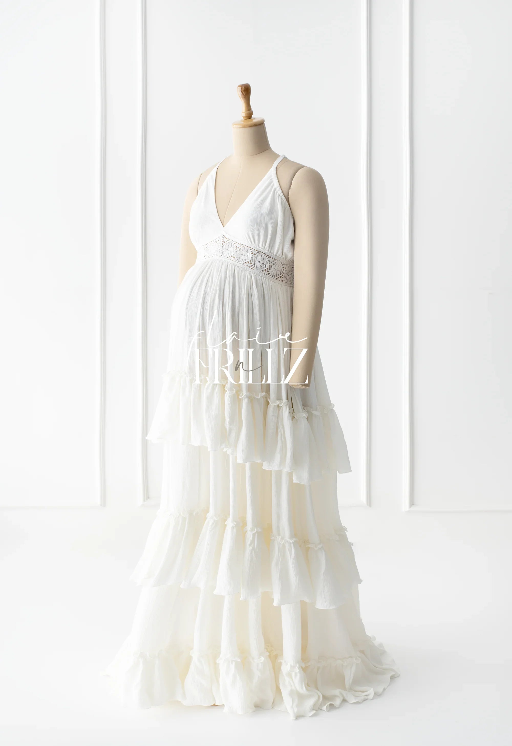 White boho maternity gown with lace waist and tiered ruffle skirt on mannequin