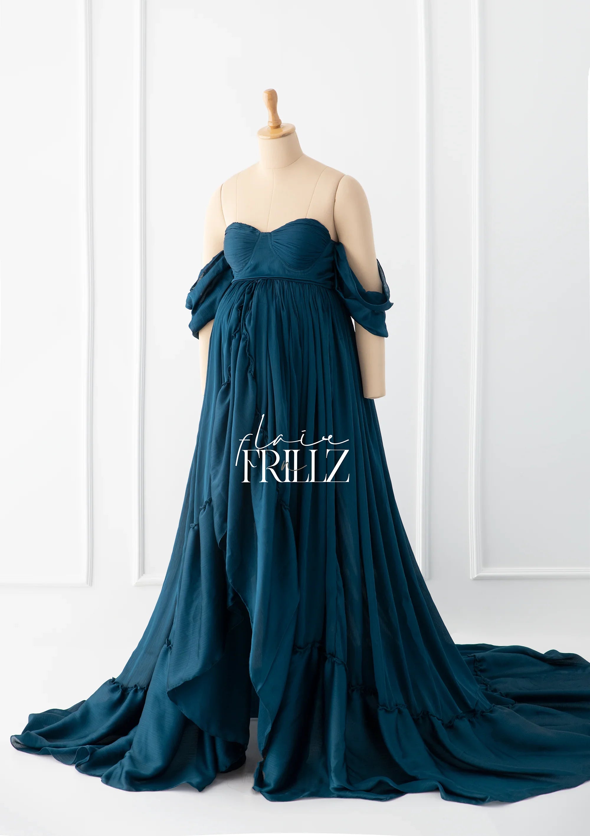 Teal off-shoulder maternity gown with flowing fabric and sweetheart neckline on mannequin