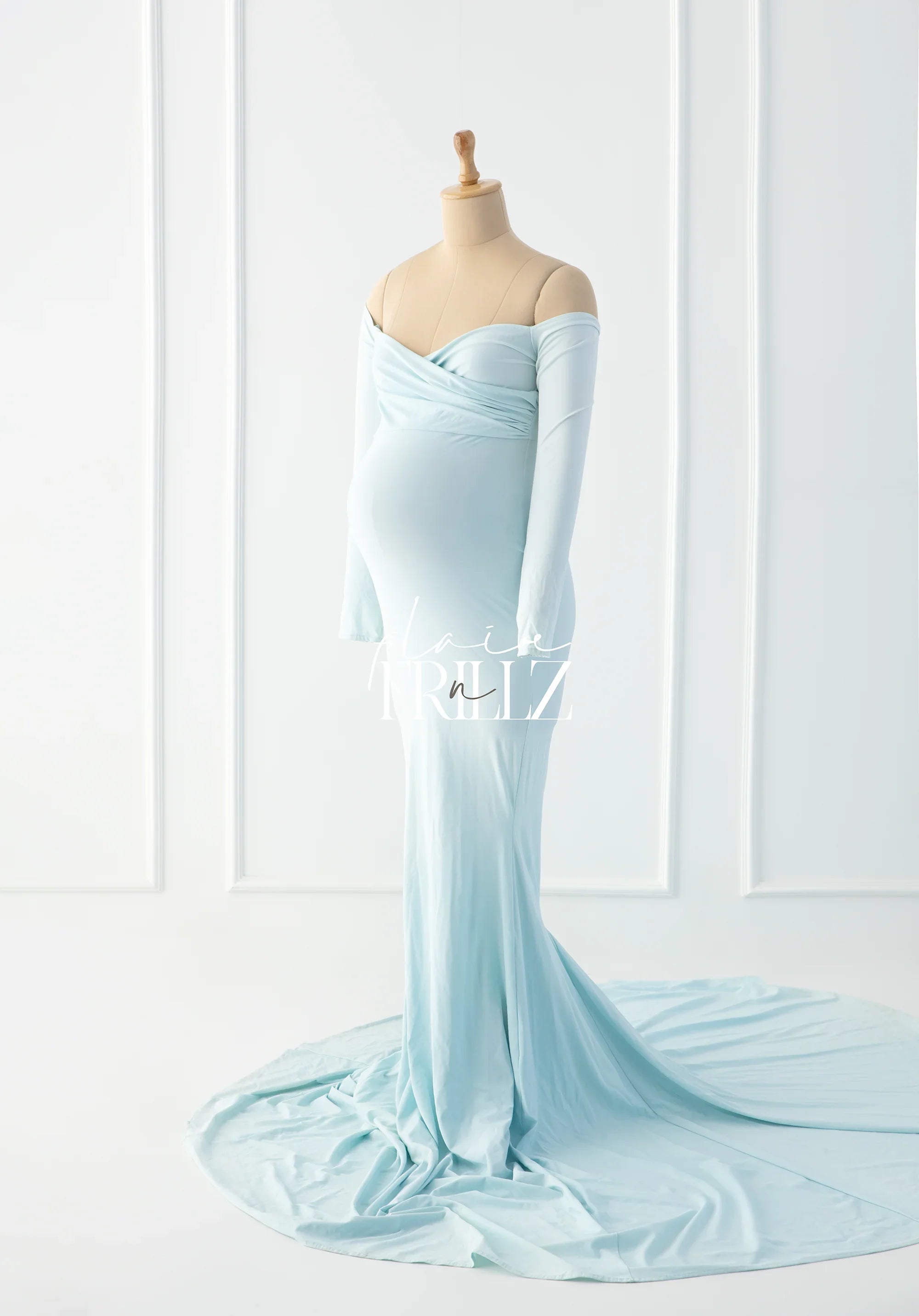 Light blue off-shoulder maternity gown with a long train, displayed on a dress form
