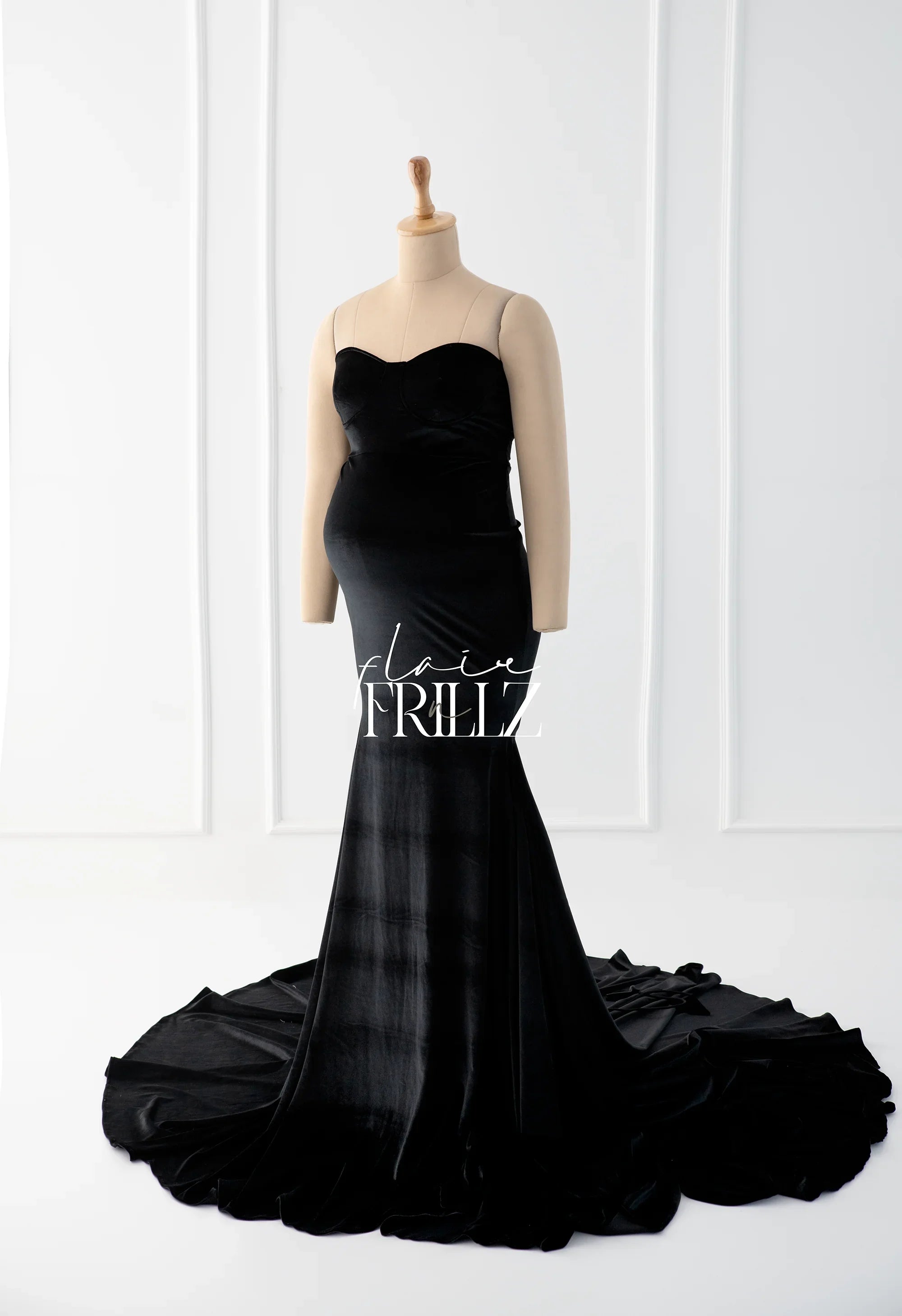 Black velvet maternity gown with sweetheart neckline and long train on mannequin